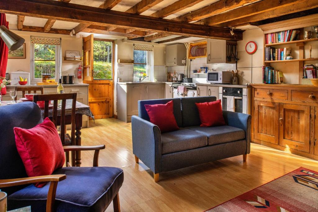 a living room with a couch and a kitchen at Finest Retreats - Great Cantal Granary in Llandrindod Wells