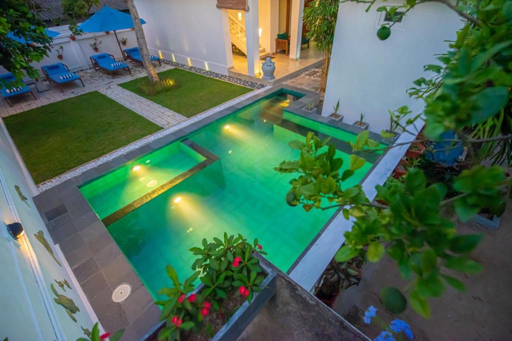 an overhead view of a swimming pool with lights at The Residence Hikkaduwa in Hikkaduwa