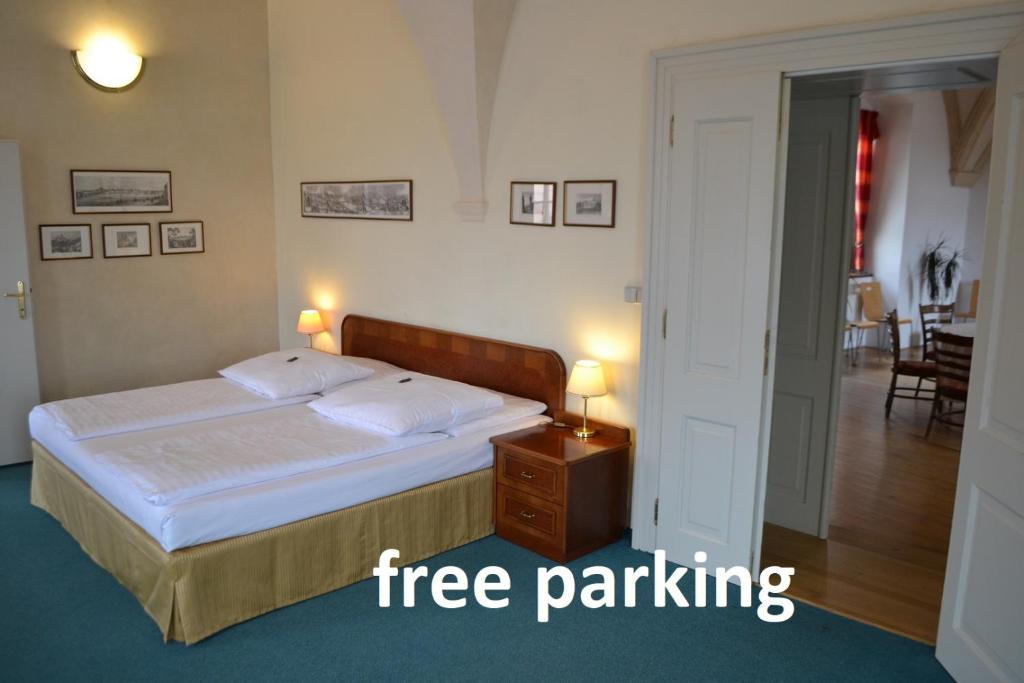 a bedroom with a bed with a free parking sign at Adalbert Ecohotel in Prague