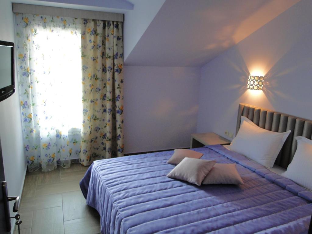 Postel nebo postele na pokoji v ubytování Hotel Olympos