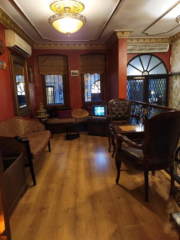 a living room with a table and chairs at Istanbul Irish Hotel in Istanbul