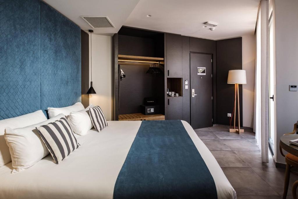 Postel nebo postele na pokoji v ubytování Urban Rooms by NEU Collective