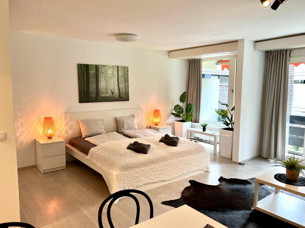 a bedroom with a large bed and a living room at Jutta Deluxe Apartment #325 in Bad Reichenhall