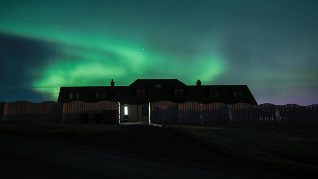 a large building with a sky background at Decca - Self Catering Shetland in Lerwick