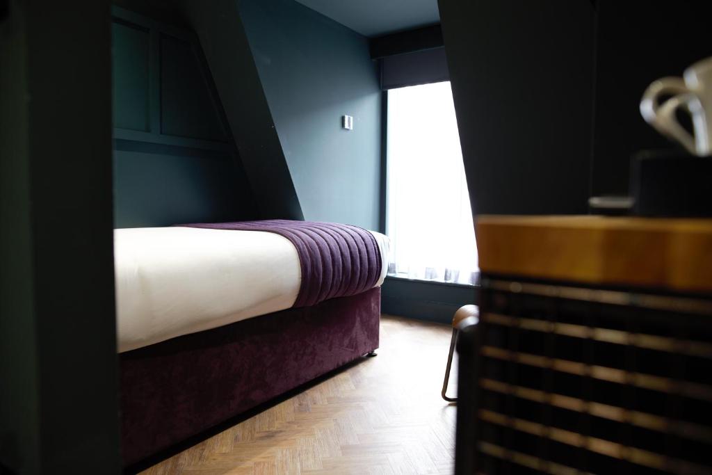 A bed or beds in a room at Duke Street Boutique Hotel
