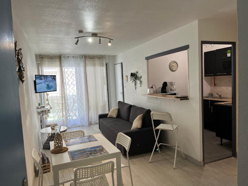 a living room with a couch and a table at La galinette sétoise in Sète