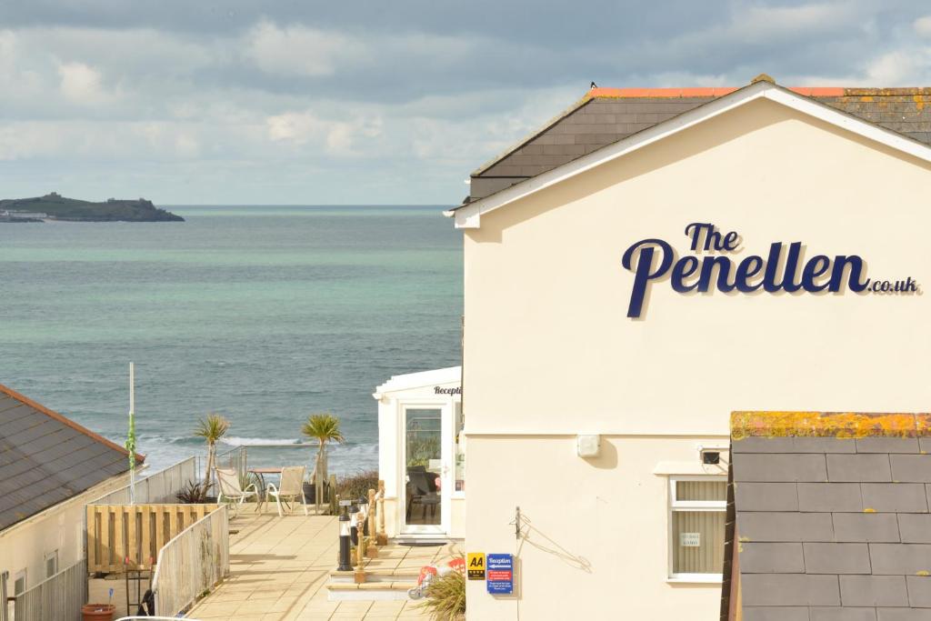 a white building with a sign that reads the perrier at The Penellen guest accommodation room only in Hayle