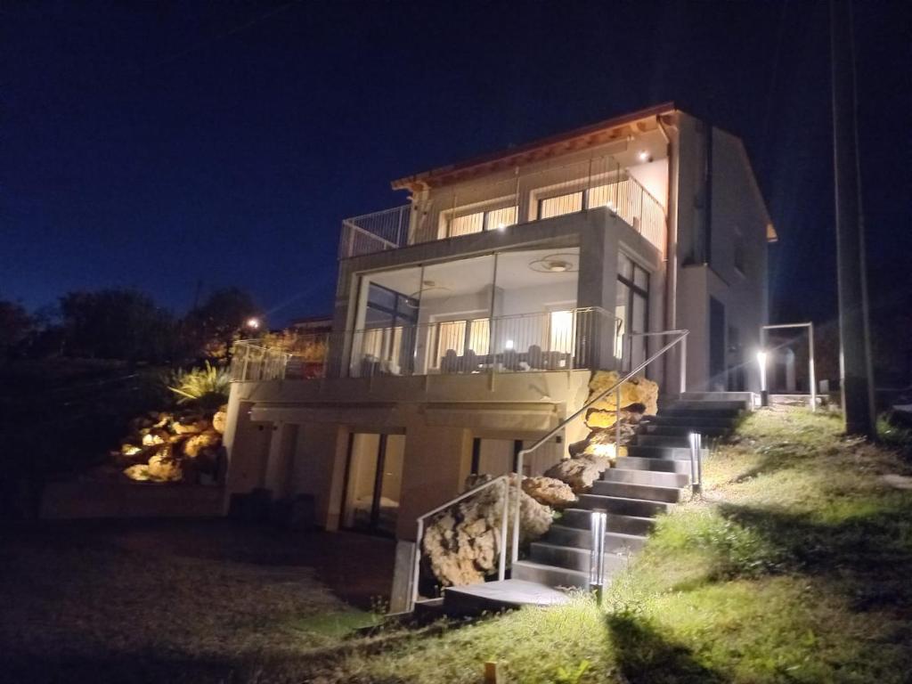 a house with stairs leading up to it at night at TERRAZZA SAN VETTORE camere con colazione, Relax in collina con vista sui vigneti DOCG ASOLO in Maser