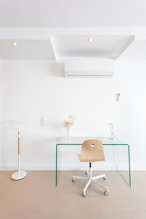an office with a glass desk and a chair at Rooms & Suites Loft 2G Deluxe Edition Arrecife in Arrecife