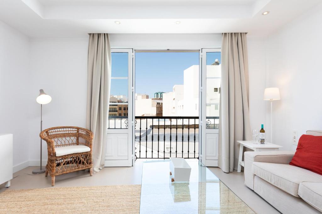 a living room with a couch and a balcony at Rooms & Suites Loft 2G Deluxe Edition Arrecife in Arrecife