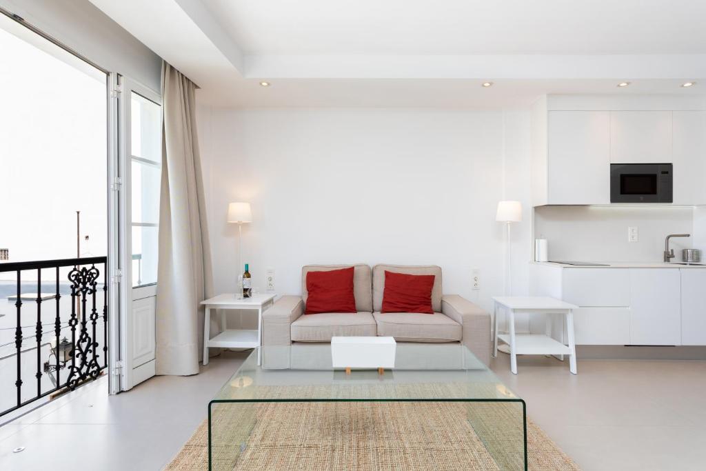 a living room with a couch and a table at Rooms & Suites Loft 2G Deluxe Edition Arrecife in Arrecife