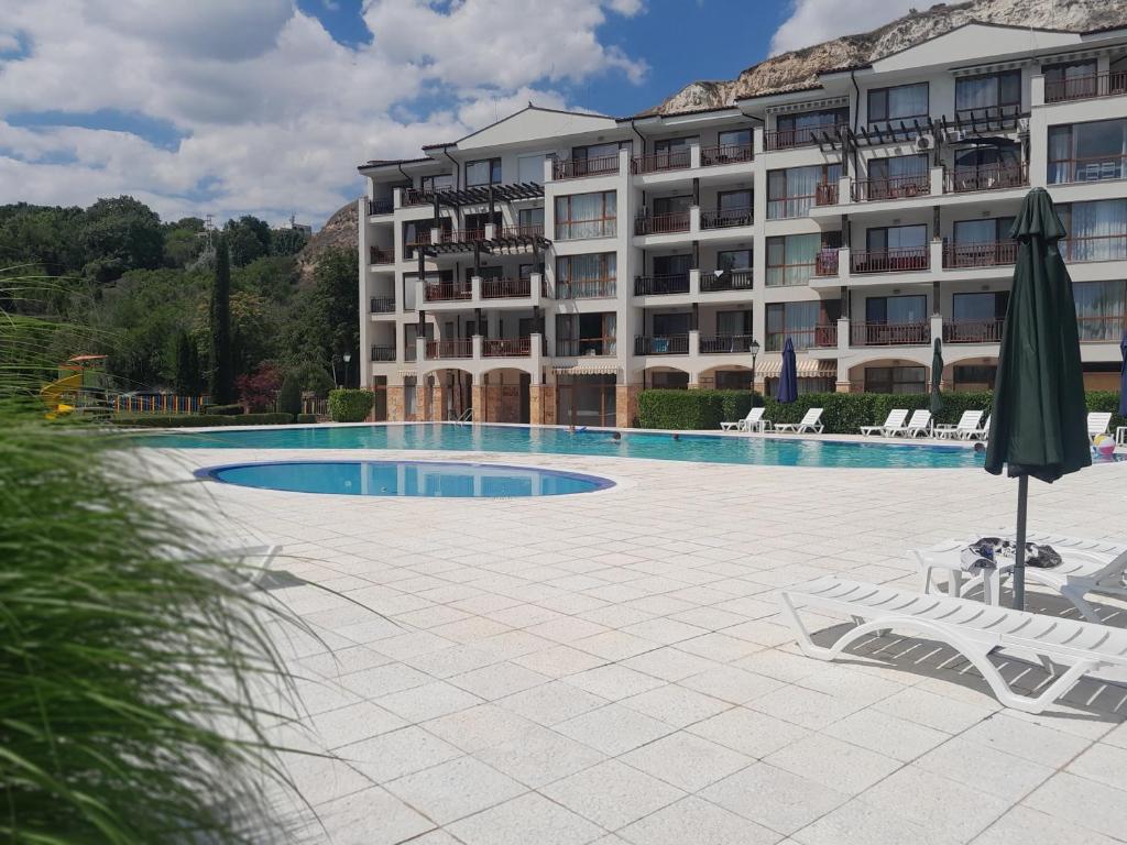 a large apartment building with a large swimming pool at Balchik Gardens complex SeaHome 21 apartment in Balchik