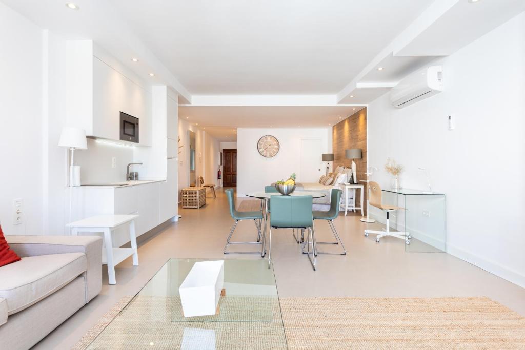 a living room with a couch and a table at Rooms & Suites Loft 2G Deluxe Edition Arrecife in Arrecife