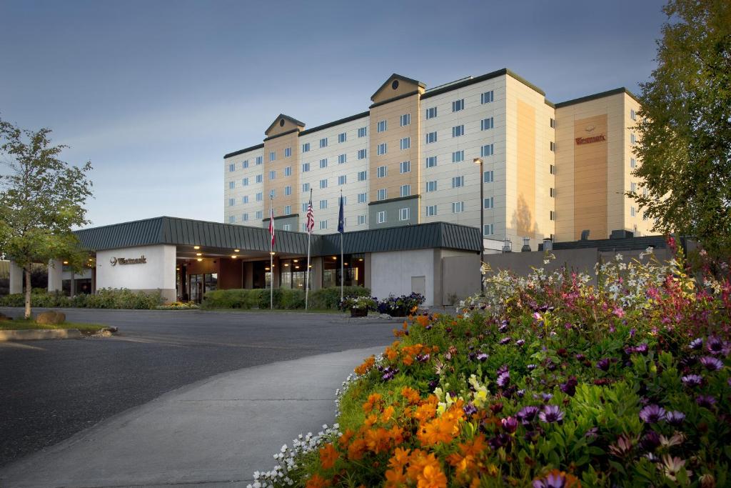 a hotel with a lot of flowers in front of it at Westmark Fairbanks Hotel and Conference Center in Fairbanks