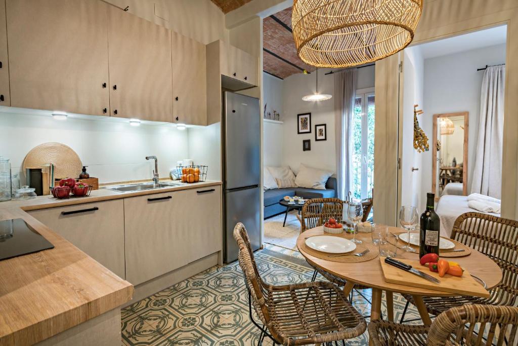 a kitchen and dining room with a table and chairs at Habitat Apartments Sweet Sagrada Familia in Barcelona