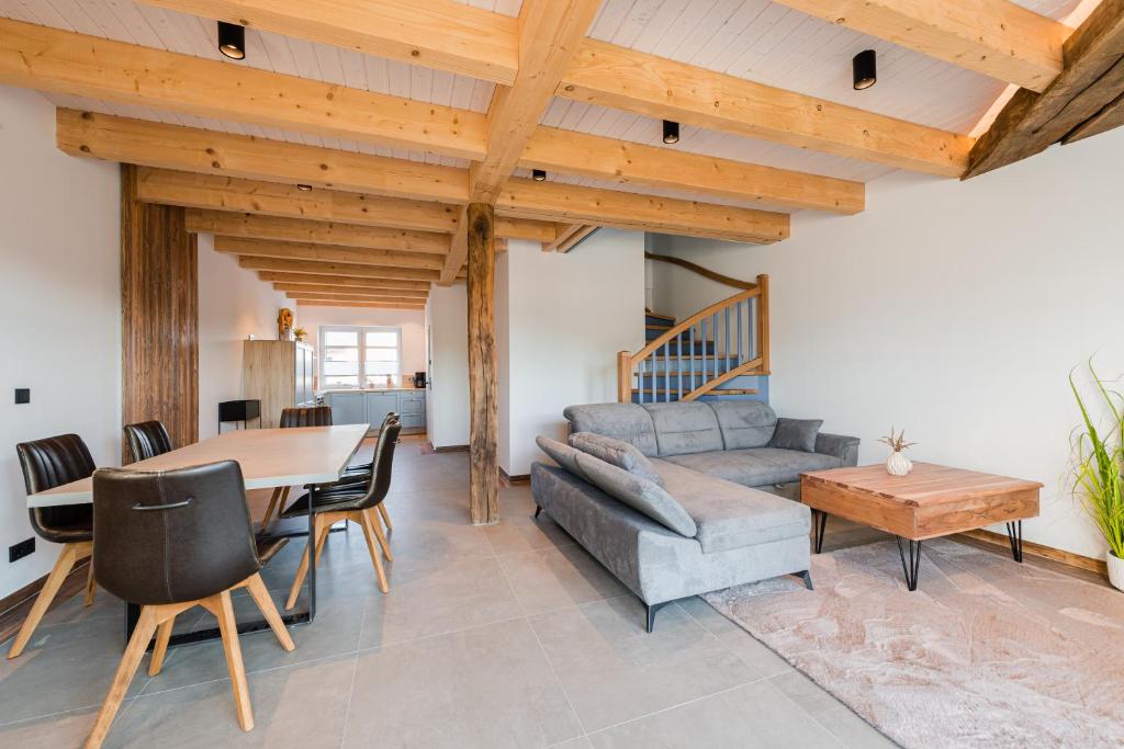 a living room with a table and a couch at Ferienpark Harkebrügge Haus Borkum in Barßel