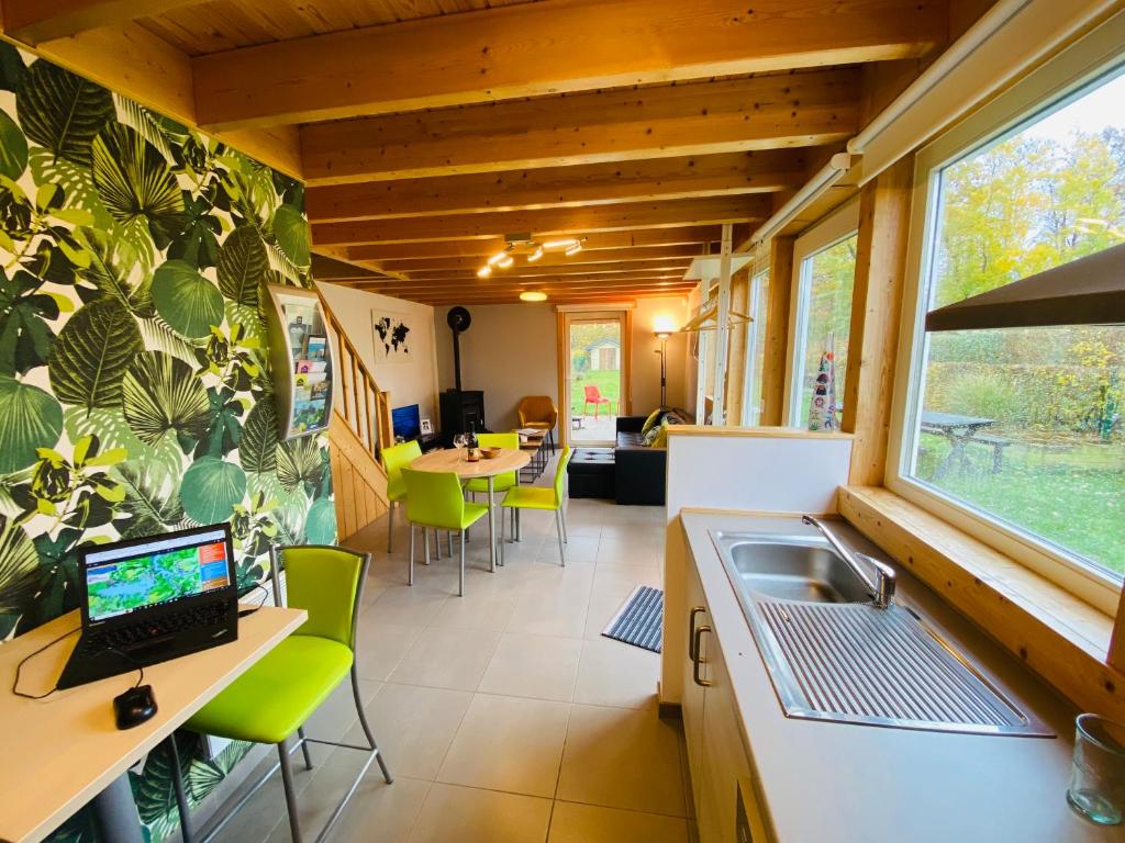 a kitchen with a laptop on a counter in a tiny house at L'écureuil des Lacs-4 pers in Froid-Chapelle