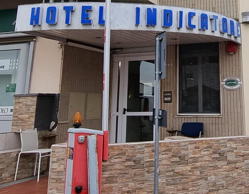 a hotel sign in front of a building at Hotel Indicatore Budget & Business At A Glance in Campi Bisenzio