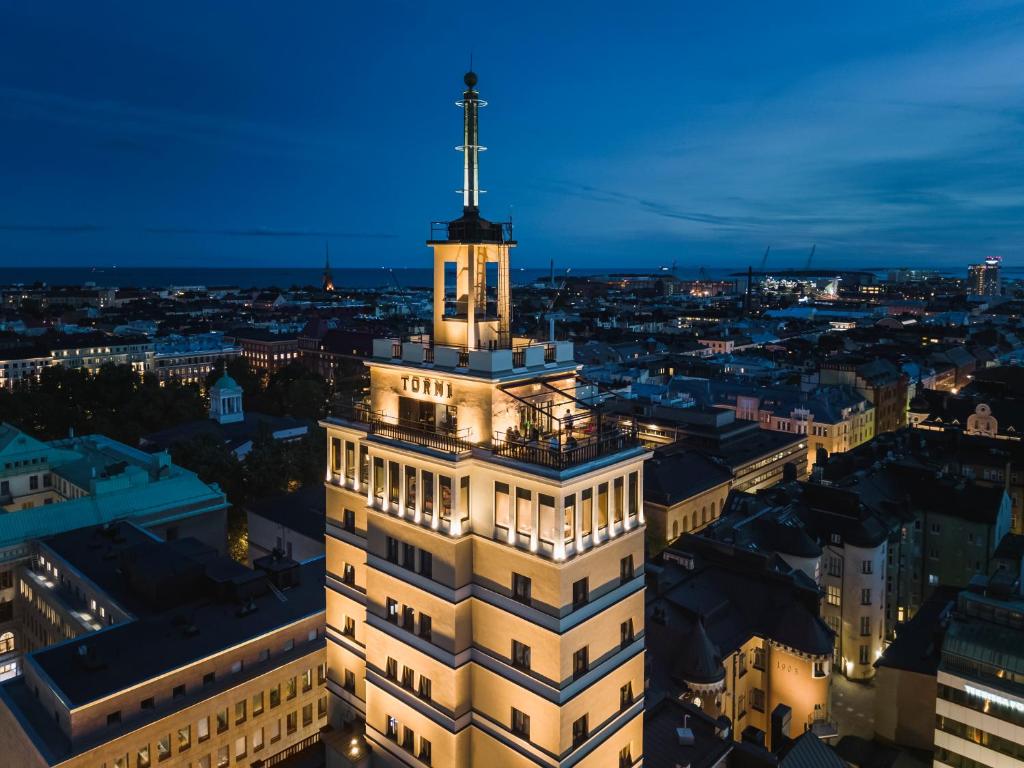 a building with a cross on top of it at night at Solo Sokos Hotel Torni Helsinki in Helsinki