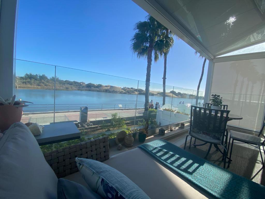 a living room with a view of the water at Apartamento Oasis Palmeras 4 in San Bartolomé de Tirajana