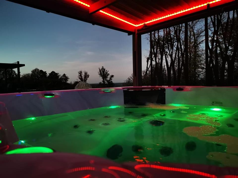 a pool with green lights on top of it at "Notre Bastide" Maison et table d'hôtes traditionnelle et végétarienne, Piscine, jacuzzi, Clim, , à 5 mn de SARLAT in Marcillac-Saint-Quentin