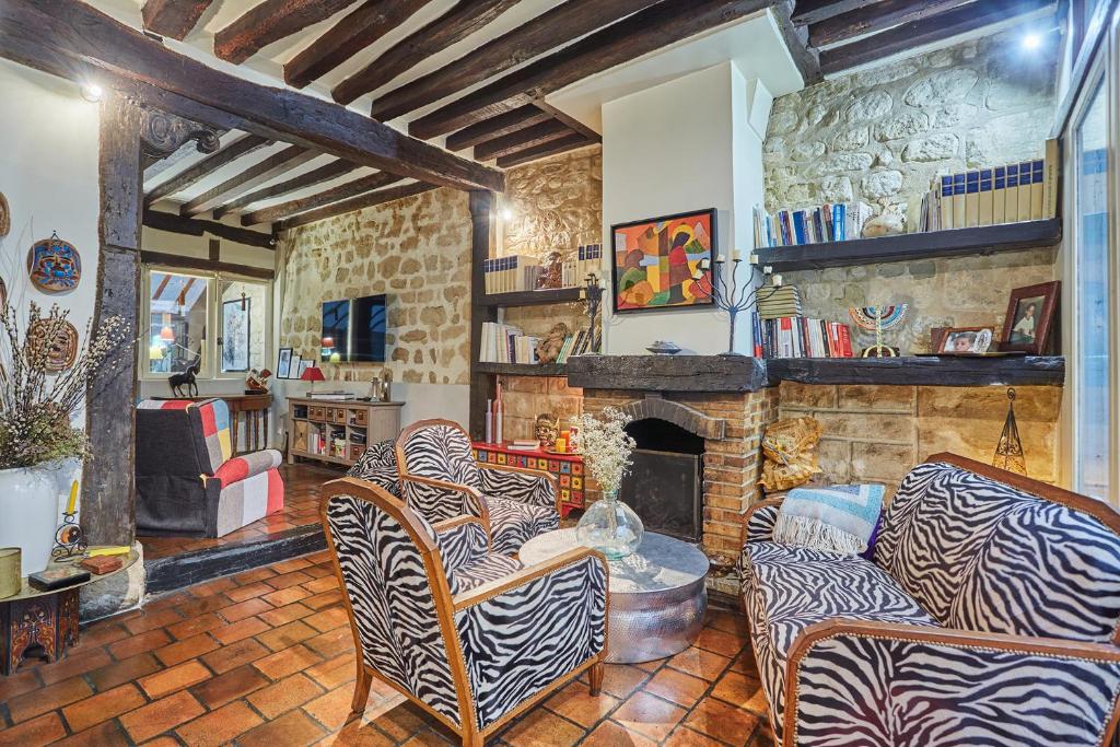 a living room with a couch and a fireplace at Apartment in heart of Marais by Studio prestige in Paris