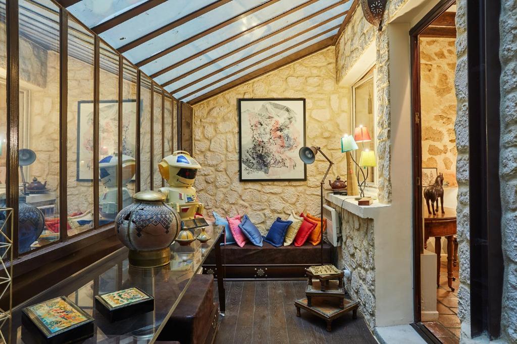 a room with a glass table with vases on it at Apartment in heart of Marais by Studio prestige in Paris