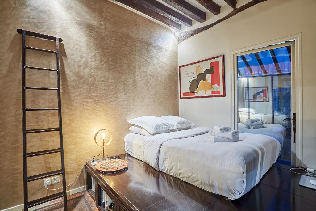 a bedroom with a bed and a ladder in it at Apartment in heart of Marais by Studio prestige in Paris