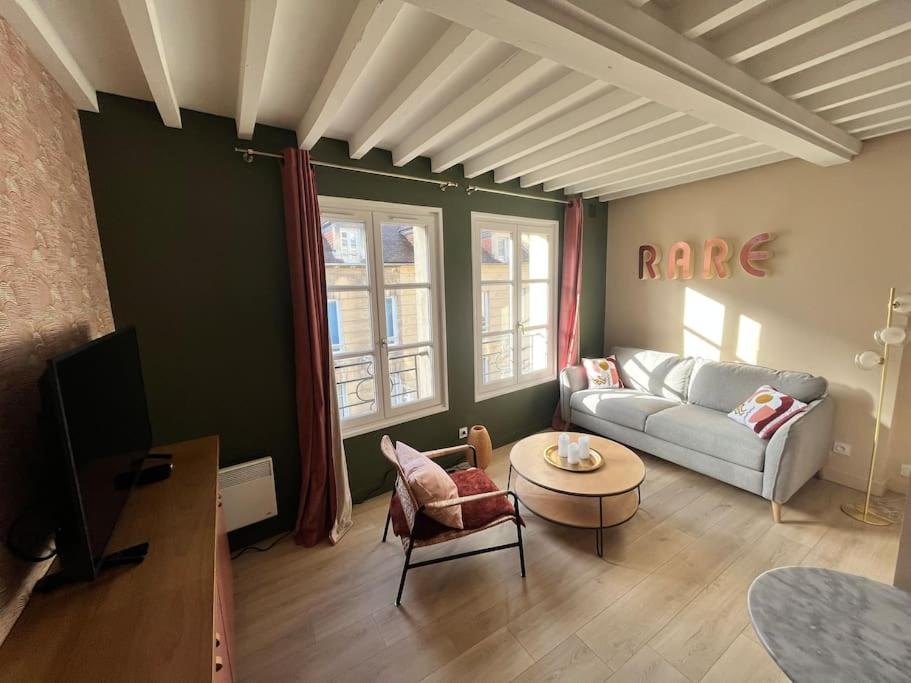 a living room with a couch and a table at Duplex 50m2 rénové, hyper-centre, St sauveur in Caen