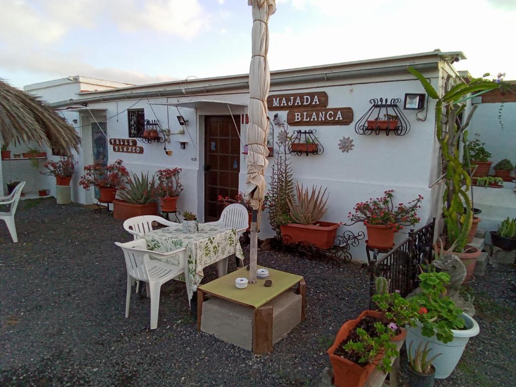 patio ze stołem i krzesłami przed budynkiem w obiekcie Majada Blanca w mieście Antigua