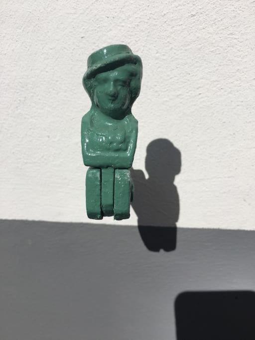 a green figurine of a person on a wall at La Maisonnette : charmante maison indépendante in Salgesch