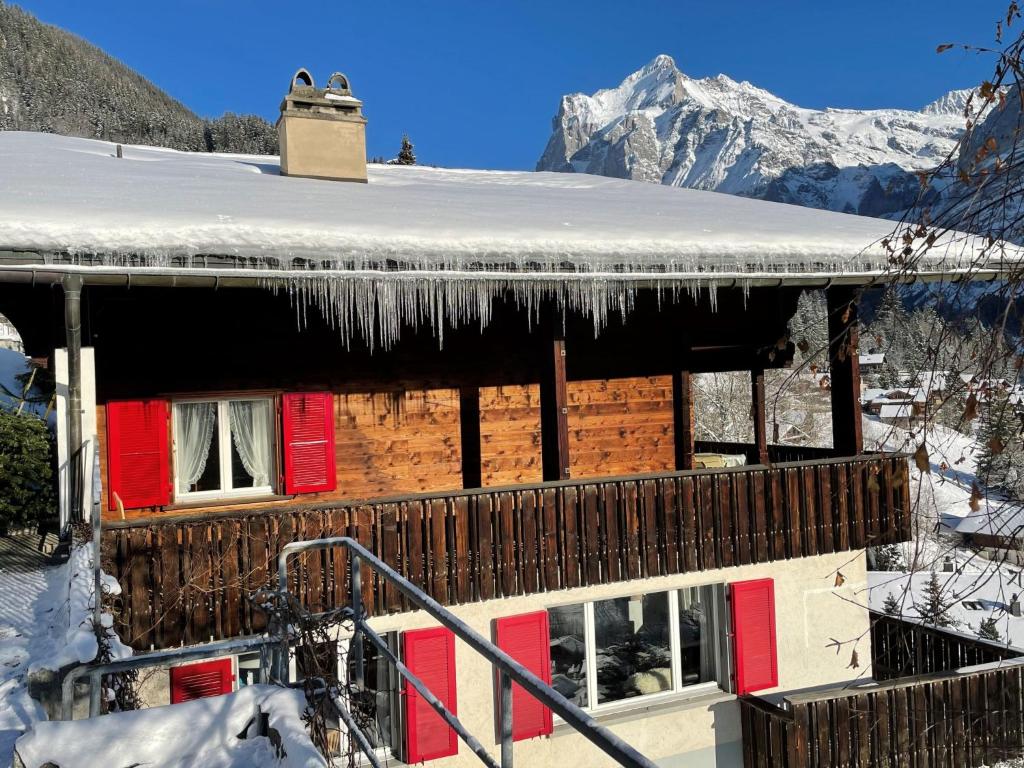 a house with snow on the roof of it at Apartment Chalet Shangri La by Interhome in Grindelwald