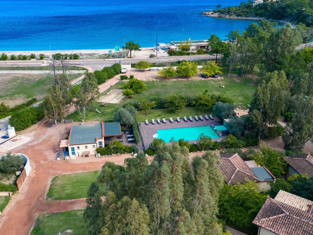 an aerial view of a house with a swimming pool and the ocean at Apartment Residence Marina di Favone- T2- 2-4 pers-1 by Interhome in Favone