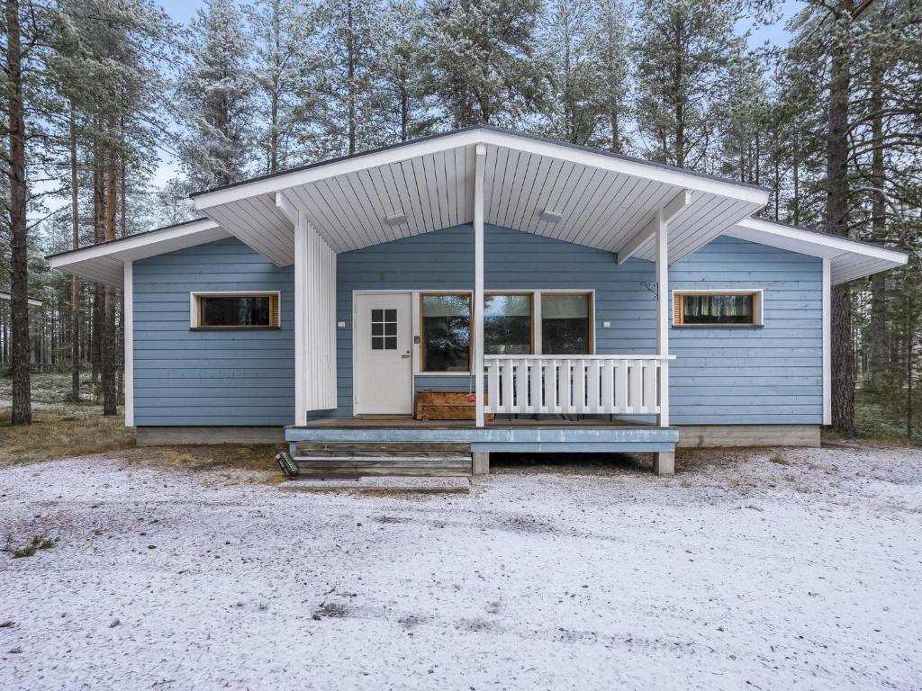 a blue tiny house in the woods at Holiday Home Villa kuukso by Interhome in Kuusamo