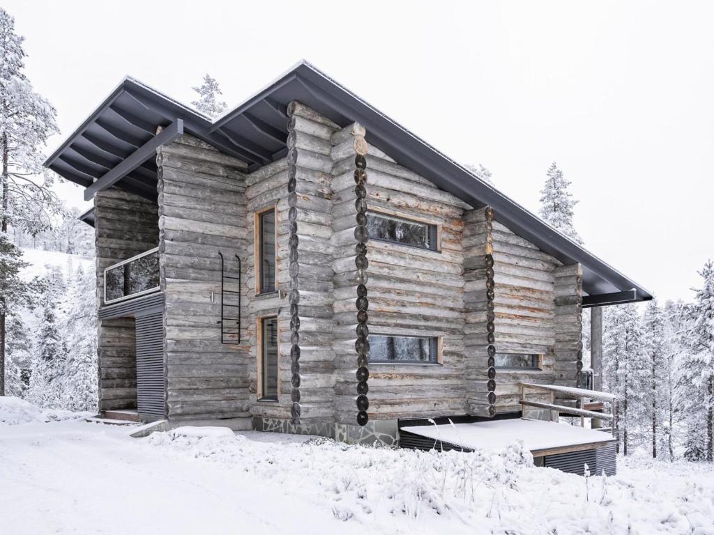 a log cabin in the snow at Holiday Home Leija by Interhome in Ruka