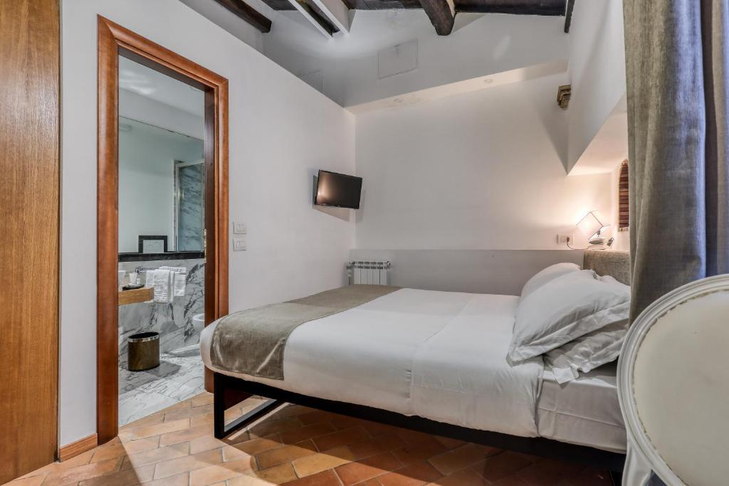 Un ou plusieurs lits dans un hébergement de l'établissement Luxury Navona