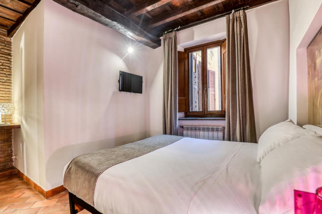 Un ou plusieurs lits dans un hébergement de l'établissement Luxury Navona