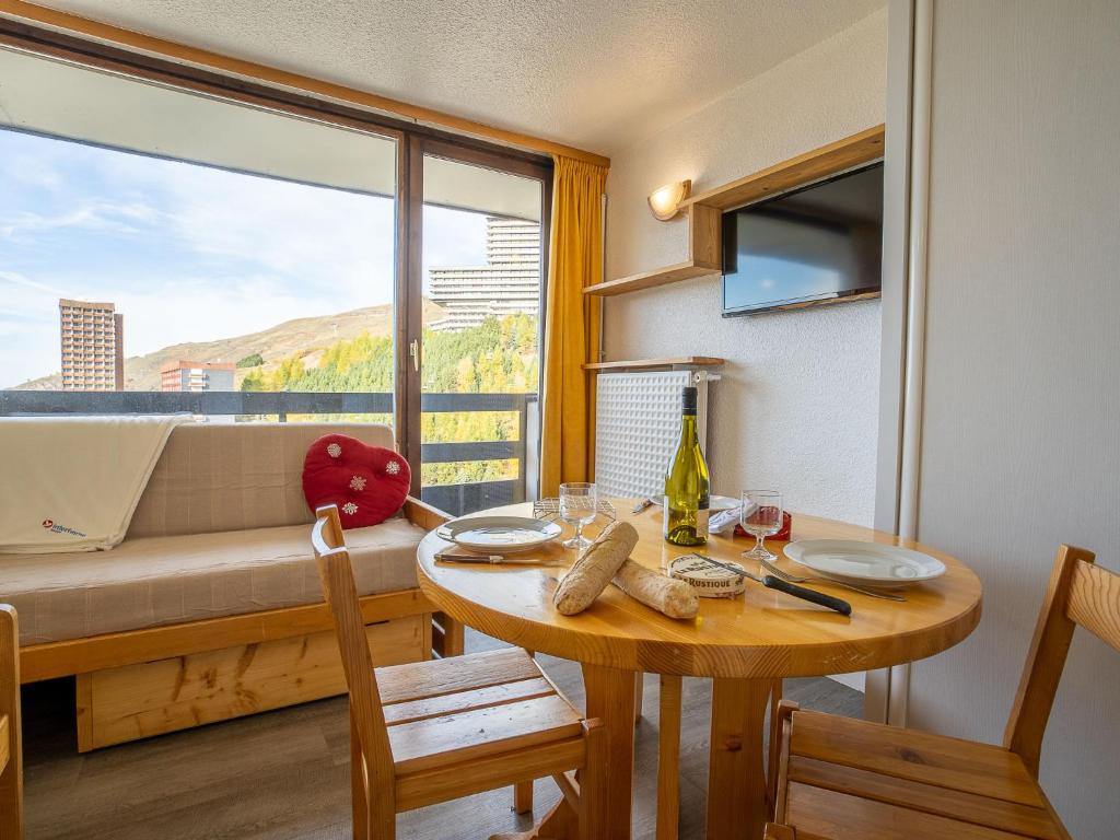 une chambre avec une table et un canapé avec une fenêtre dans l'établissement Studio Chavière 832 by Interhome, aux Menuires