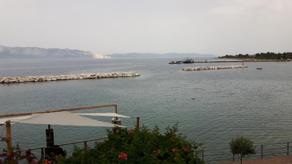 a view of a large body of water with a boat at ARTEMIS ROOMS in Pefki