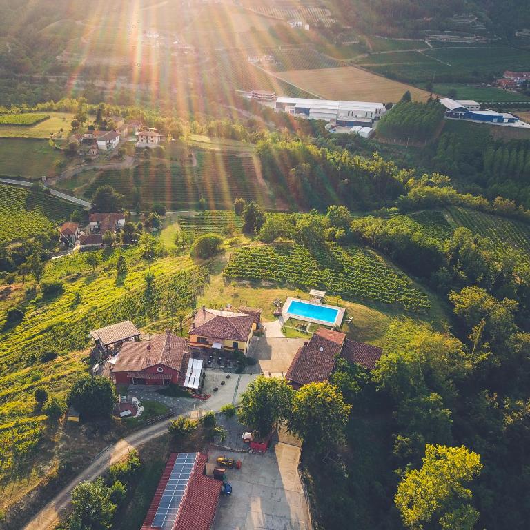 an aerial view of a house on a hill with a pool at Tenuta MonteOliveto - Cottage Relax - Agriturismo nelle Langhe in Vesime
