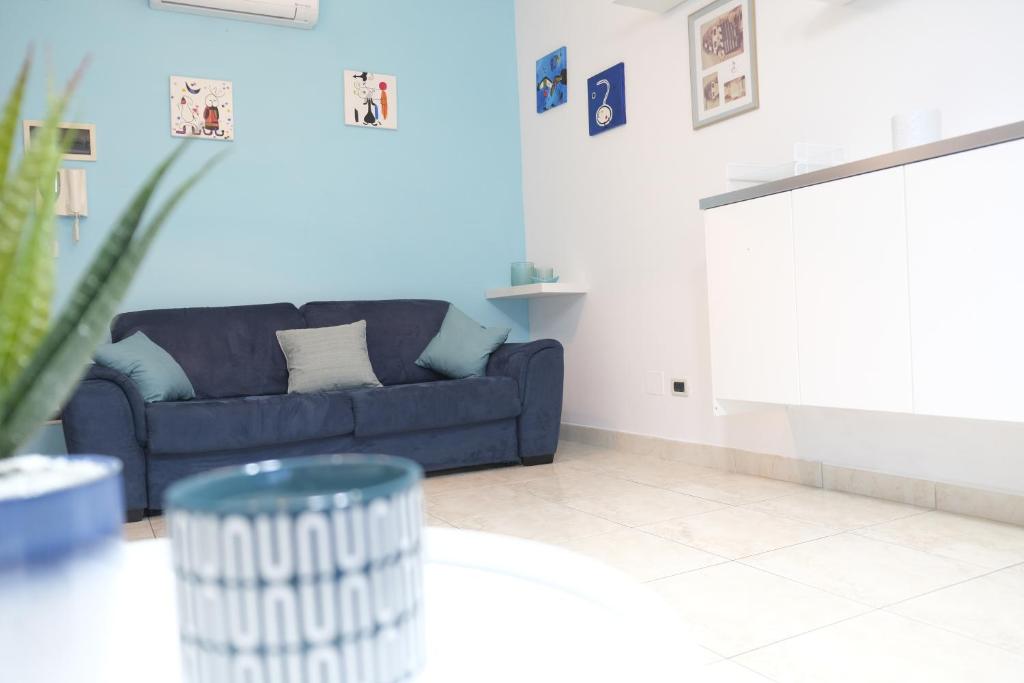 un soggiorno con divano blu e tavolo di Light Blue House a Montesilvano
