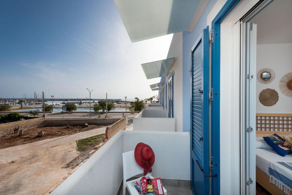 a room with a view of the beach from a house at VOGLIA D'ESTATE apartments in San Vito lo Capo