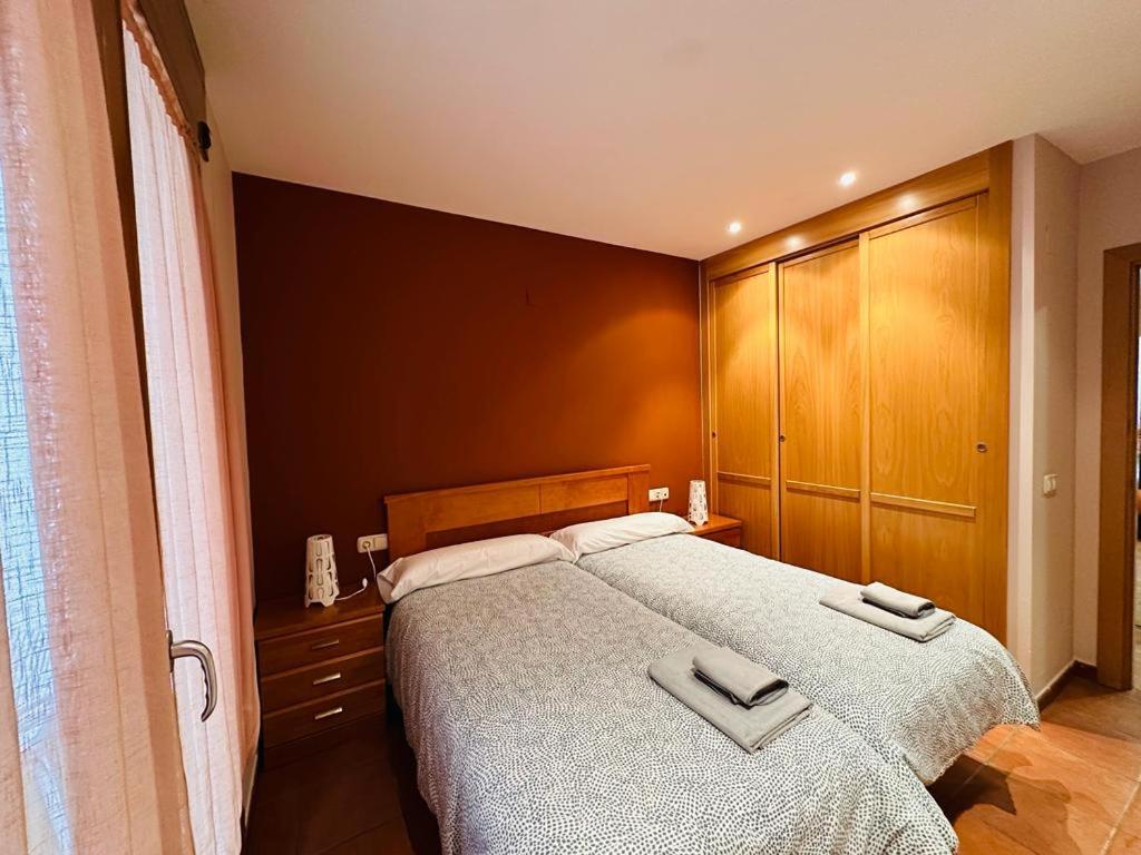 a bedroom with a large bed with two towels on it at Apartamento Carlos Bielsa in Bielsa