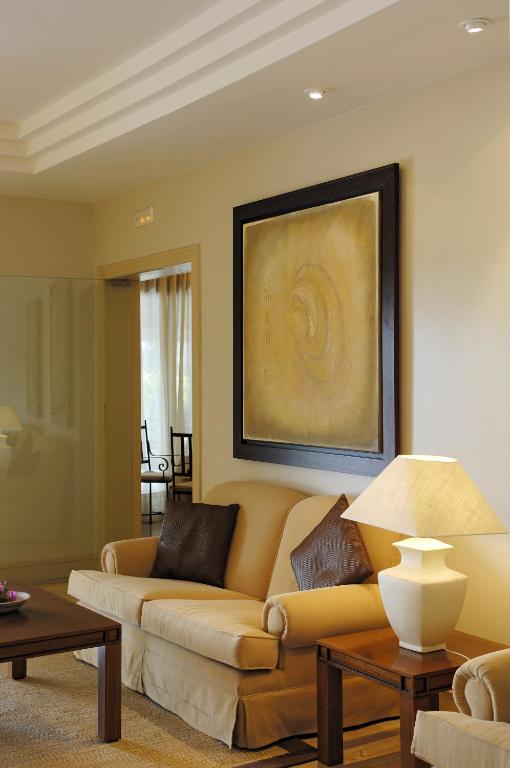 a living room with a couch and a painting on the wall at Villa VIK - Hotel Boutique in Arrecife