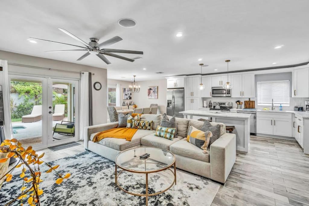 a living room with a couch and a table and a kitchen at Dinas Home with Modern Interior and Heated Pool in Delray Beach