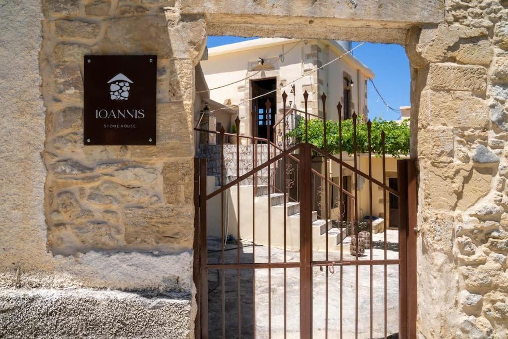 an entrance to a building with an iron gate at IOANNIS STONEHOUSE, Quiet, Privacy & Sea View. in Kissamos