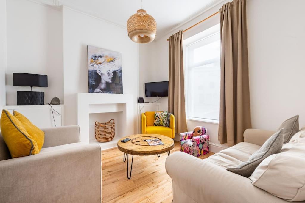 a living room with a couch and a table at Penarth Townhouse close to Cardiff & Bay in Cardiff