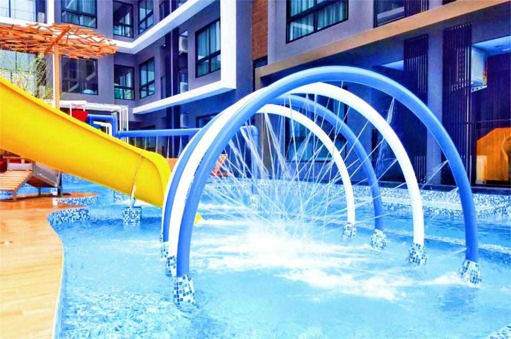 a water slide in a pool in a building at Hua Hin First - Ji Ya in Hua Hin