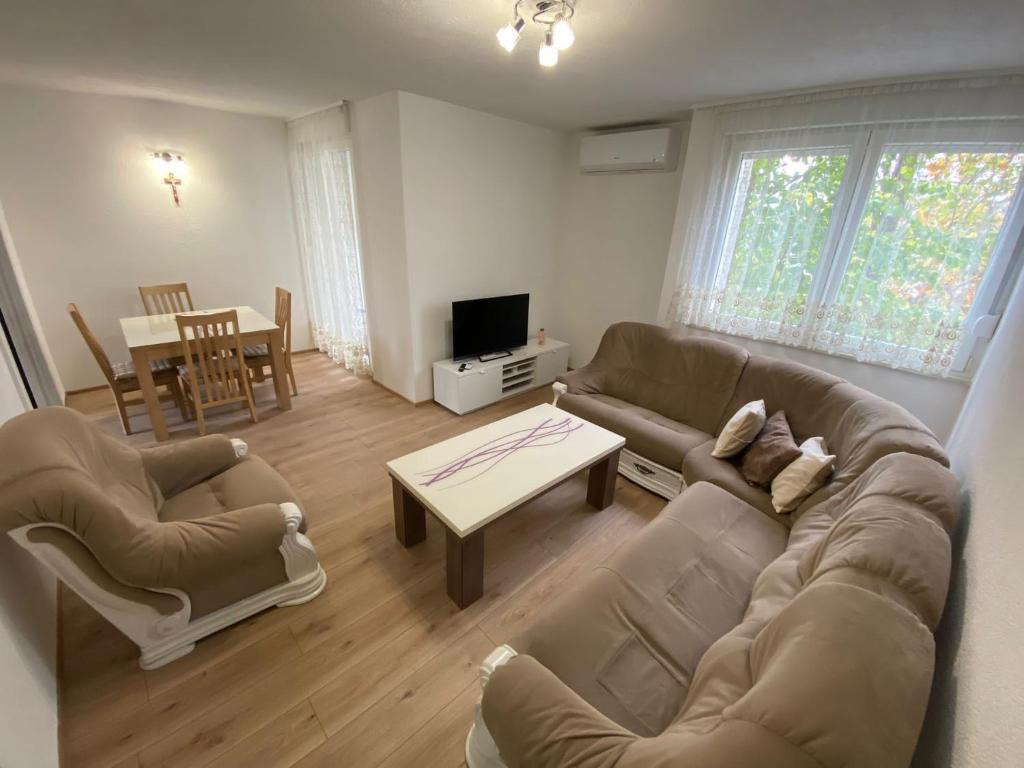 a living room with two couches and a table at Apartman Palac in Grude