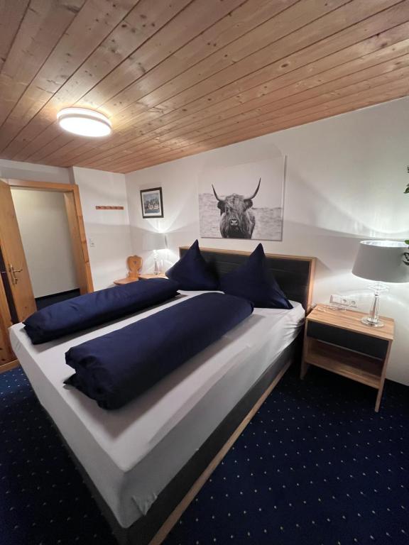 a bedroom with a bed with a bull head on the wall at Appartement Bichl in Sölden